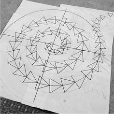 a drawing is shown on the ground next to some papers with arrows in it and one has been drawn