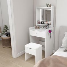 a bedroom with a white vanity table and stool next to the mirror on the wall