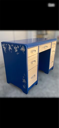 an image of a blue desk with drawers on the top and bottom part of it