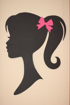 the silhouette of a woman's head with a pink bow in her hair is shown