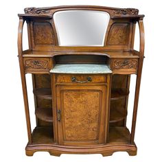 an antique wooden vanity with marble top and mirror on it's sideboard,