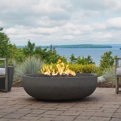 a fire pit sitting on top of a brick patio