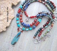 Colorado Springs, Boho Style Me Colorful Rustic Style Multi Strand Gemstone Necklace, BohoStyleMe, Artisan Beaded Turquoise Necklace In the style of the rustic Colorado mountains, this colorful, rustic, mixed gemstone necklace stands out as a striking multiple strand statement necklace. Starting with a beautiful chrysocolla beaded pendant is a trail of genuine turquoise, lapis lazuli, carnelian, labradorite, iolite, sodalite, and a large mix of jasper stones. Directly above the pendant is strand Blue Bohemian Beaded Necklaces With Stones, Bohemian Blue Beaded Necklaces With Stones, Multicolor Bohemian Turquoise Necklace With Stones, Bohemian Multicolor Turquoise Necklace With Stones, Multicolor Turquoise Bohemian Necklace, Bohemian Multicolor Turquoise Necklace, Multicolor Bohemian Turquoise Necklace With Round Beads, Bohemian Multicolor Turquoise Necklace With Round Beads, Bohemian Multicolor Turquoise Beads Necklace