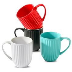 three different colored mugs sitting next to each other