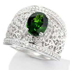 The color of the season! Featuring a beautiful shade of green, this ring sizzles with ornate scrollwork detailing that cushions a large chrome diopside. White zircon accents sparkle like diamonds on this wide band ring. Green Emerald Ring With Intricate Design, Elegant Green Oval Filigree Ring, Oval Green Emerald Ring With Intricate Design, Green Oval Emerald Ring With Intricate Design, Elegant Green Filigree Ring For May Birthstone, Ornate Green Oval Filigree Ring, Ornate Green Emerald Anniversary Ring, Chrome Diopside Ring, Jewelry Closet