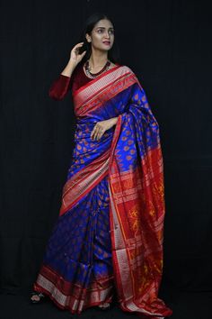 Exclusive hand-woven Sambalpuri silk saree with tribals. Finest pure handwoven sambalpuri ikat silk saree with traditional motifs woven by the master weavers of Sambalpur, Odisha. It has lovely patterns and is world-famous for its stunning colours, texture and designs. Occasion: Party Wear Fabric: Sambalpuri Primary Color: Blue Secondary Color: Red Material: Mulberry Silk/ Sambalpuri Silk Pattern: Motif Border Type: Ikkat Border Size: Medium Blouse Piece: Included Care: Dry Clean Disclaimer : This is a genuine handwoven piece, unevenness in the selvedge and weave could be expected and colours may fade or bleed due to the traditional dyeing method employed. Festive Banarasi Silk Traditional Wear With Ikat Print, Transitional Tussar Silk Saree With Ikat Print, Transitional Season Tussar Silk Saree With Ikat Print, Banarasi Silk Traditional Wear With Ikat Print, Banarasi Silk Saree With Ikat Print And Traditional Drape, Traditional Banarasi Silk Wear With Ikat Print, Festive Art Silk Saree With Ikat Print, Festive Tussar Silk Saree With Ikat Print, Traditional Wear With Ikat Print And Banarasi Silk