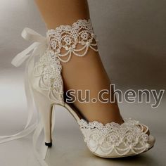 the bride's shoes are adorned with white lace and flower embellishments