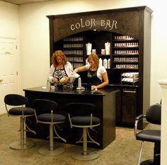 two women sitting at a counter in a salon