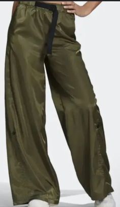 Elevate your wardrobe with these stylish Women's SMALL Adidas Wide Leg Satin Cargo Pants HF2099 in Focus Olive. The pants feature an elastic waistband with an adjustable buckle, making them comfortable to wear for any occasion, whether it's a casual daytime look or a formal evening event. The pants come with multiple pockets, making it easy to carry your essentials on the go. The satin fabric and green color give these pants a luxurious look that is perfect for any season. (CL-30A-5) Satin Cargo Pants, Satin Pants, In Focus, Satin Fabric, Stylish Women, Green Color, Cargo Pants, Adidas Originals, Olive Green