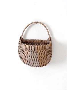 a woven basket hanging on the wall