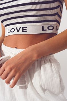 Introducing our stylish Striped Crop Top with Love Text in White, a trendy and comfortable addition to your wardrobe. Designed with attention to detail, this crop top offers a perfect blend of style and comfort. With its cropped length, this top is perfect for creating a fashionable and contemporary look. The stripe design adds a touch of sophistication, while the contrast collar adds a stylish element to the overall design. The sleeveless style allows for ease of movement and breathability.  Th Chic Cotton Crop Top, Trendy Cropped Crop Top For Day Out, Chic White Slightly Cropped Top, Chic Slightly Cropped White Crop Top, Chic Fitted Crop Top With Elastic Waistband, Chic Cropped Hem Crop Top For Summer, Chic Spring Crop Top With Elastic Waistband, Casual Cropped Crop Top For Day Out, White Summer Crop Top For Loungewear