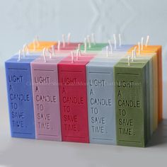 small candles with different colors and sayings on them