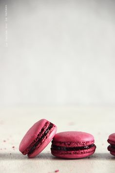 three pink macaroons sitting next to each other