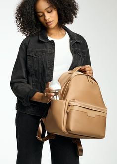 Crafted from our high-quality nylon and designed with ample storage space, the Eli backpack boasts a modern, minimalist design that complements various styles. A dedicated compartment for a 13" laptop, multiple pockets, and organizational features make it ideal for both work and play. Whether you're heading to the office, school, or a weekend adventure with your littles, Eli is the perfect companion. Common Uses: Diaper Bag, Work Bag, Travel Bag Insulated Siding, Unicorn Bag, Stroller Hooks, Backpack Reviews, Modern Minimalist Design, Monogrammed Items, Backpack Straps, Work Bag, Changing Pad