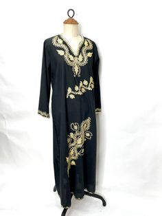 Gold embroidered vintage 70s black cotton caftan. Lightweight and easy, giving hippie witch vibes. Black Thobe With Floral Embroidery And Long Sleeves, Black Long Sleeve Thobe With Floral Embroidery, Black Long Sleeve Festival Kaftan, Black Bohemian Kaftan For Eid, Bohemian Black Kaftan For Eid, Bohemian Embroidered Kaftan For Fall, Bohemian Long Sleeve Abaya For Fall, Bohemian Black Thobe For Eid, Black Bohemian Thobe