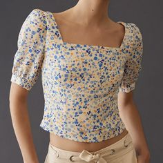 a woman with short hair wearing a crop top