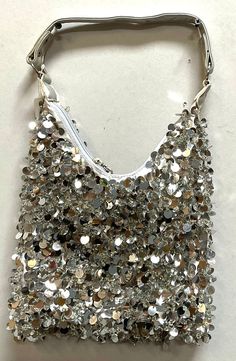 This cool and funky purse is perfect for pairing up with a cute dress! Chic Sequined Shoulder Bag For Party, Trendy Silver Party Bags, Casual Party Shoulder Bag With Zipper Closure, Casual Shoulder Bag With Zipper Closure For Parties, Chic Silver Bag For Summer, Chic Silver Bags For Summer, Glamorous Sequin Shoulder Bag, Glamorous Summer Clutch Bag, Silver Shoulder Bag For Everyday Summer Use