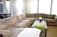 a living room with two couches and a coffee table in front of the window