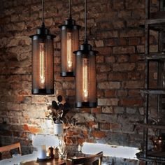 three lights hanging over a dining room table