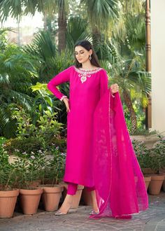 • Fuchsia pink rawsilk handworked shirt with work on neckline (front and back) and sleeves with zardozi and dabka • Paired with matching rawsilk cigarette pants • Add on a matching pure katan organza dupatta with gota on four sides (Includes Shirt and pants) Slub Silk Lawn Suit With Gota Work For Wedding, Wedding Lawn Suit With Gota Work In Slub Silk, Pink Raw Silk Kurta With Mirror Work, Pink Raw Silk Kurta With Dabka Work, Designer Pink Silk Lawn Suit, Pink Silk Lawn Suit Designer Wear, Pink Silk Lawn Suit For Designer Wear, Pink Dabka Work Dola Silk Kurta, Pink Dola Silk Kurta With Dabka Work