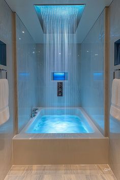 Modern bathroom with a walk-in shower and a freestanding bathtub combo, featuring blue ambient lighting and a waterfall showerhead. Perfect for a relaxing bath. Shower With Sink Inside, Small Bathroom Ideas With Shower Walk In, Bath Tub Ideas, Walk In Tub Shower, Woman Bathroom