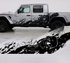 a white jeep parked in a garage next to a black and white painting on the wall