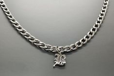 "Silver Gold Custom Curb Chain Old English Initial Necklace for Men is a great holiday Gift. This Necklace can be made  by Silver and Gold PVD coating on Stainless Steel which is tarnish resistant, waterproof, same functions as 18K gold filled.  
 The chain size is 3mm, 5mm or 7mm, which is also perfect for Women's initial necklace or couple jewelry. Perfect gift for Dad, Husband, Wife, Girlfriend, Boyfriend.  
 Our shop is committed to excellence, offering you a product that not only meets but exceeds your expectations. 
 ✔ EXCEPTIONAL CRAFTSMANSHIP: Each of our bracelets is a masterpiece of detail and design, individually tailored to the perfect length for a personalized touch that's distinctly you. 
 ✔ DURABILITY AND QUALITY: Our quality control system is stringent, ensuring each bracel Initial Necklace For Men, Pvd Coating, Initial Pendant Necklace, Couple Jewelry, Gifts For Brother, Men's Necklace, Chunky Necklace, Initial Pendant, Necklace Personalized