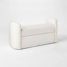 a white couch sitting on top of a white floor