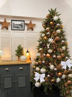 a christmas tree with gold and silver decorations