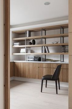 a chair sitting in front of a bookshelf