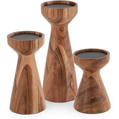 three wooden candlesticks and one candle holder