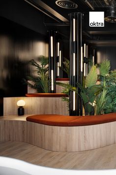 the interior of an office building with plants and lights