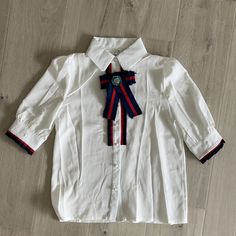 Gucci Style Looking Blouse With A Brooch. Buttons Are Plastic. Never Worn. No Brand Name Size Listed As Small Looks Like It’s Made Of Polyester Material Armpit To Armpit 17.5 Inches Length 24 **** Selling Skirt Separately**** White Bow Blouse For Work, White Bow Blouse For Workwear, White Bow Top For Work, White Bow Tops For Work, Elegant White Top With Ribbon, Elegant White Tops With Ribbon, Classic White Tops With Bow, Classic White Blouse With Bow, White Bow Blouse For Party