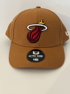 NEW ✨ OSFA Ultra Game NBA Miami Heat Logo Brown Khaki Hat Cap ✨ One size fits most Great Present !!! Terms of Sale  We ship to your eBay address. Please make sure your eBay address is correct before you pay. Payment Payment must be received within 5 days of an auction closing Florida residents will be charged FL sales tax Buyer pays return shipping Shipping Information Items shipped within 1- 2 business day of payment unless otherwise stated Estimated delivery dates are estimates only, items are Adjustable Brown Snapback Hat With Curved Visor, Brown Snapback Fitted Hat For Sports Events, Sports Flat Bill Hat In Brown, Brown Cap For Sports Events, Brown Flat Bill Sports Hat, Brown Visor Hat For Streetwear, Brown Trucker Hat With Curved Brim For Sports, Brown Flat Bill Baseball Cap For Sports Events, Brown Flat Bill Hat For Sports Events