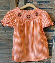 Adorable Thanksgiving smock dress. 100% cotton. Machine wash, lay flat to dry. Fits true to size. Please refer to size chart in item's pictures. :) Our smocks are made by a trusted partner within the USA. Ships within 1-3 business days.  Arrives 1-5 business days after shipped. If need it sooner, please message us, and I can send you an upgrade for shipping. Beach Smocked Cotton Dress, Cotton Smocked Dress For The Beach, Cotton Smocked Short Sleeve Top For Daywear, Cotton Smocked Dress For Beach, Cotton Smocked Top With Short Sleeves For Daywear, Cotton Tops With Smocked Bodice, Short Sleeve Gingham Smock Dress, Cotton Smocked Top For Daywear, Smocked Short Sleeve Top For Daywear