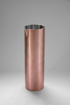 a large metal cup sitting on top of a table