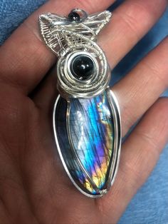 "Now Avail A stunning and very very rare Purple and Silver Rainbow Labradorite with the most beautiful fire! Paired with black tourmaline and hematite accents All woven by hand in 925 sterling silver This piece measures approximately 2.5\" x 1\" wide and will come on an adjustable leather cord necklace. Absolutely one of the prettiest labs that has come across my bench this year Please consider adding the separate listing for insuring packages All items are shipped with tracking Please enjoy the Australian Opal Pendant, Purple Rainbow, Leather Cord Necklace, Purple And Silver, Opal Pendant Necklace, Leather Corded Necklace, Opal Pendants, Black Tourmaline, Cord Necklace