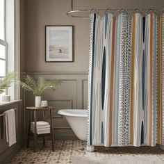 a bathroom with a bathtub, shower curtain and rug