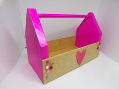 a pink cardboard box with hearts and flowers on the inside, sitting on a white surface