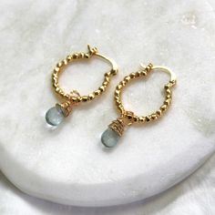 Classic and elegant these gold hoop earrings are perfect for everyday. Gold hoops adorned with genuine aquamarine drops wrapped by hand, these will be your new favorite earrings!  D E T A I L S These everyday earrings are high quality 16kt Gold Filled latch hoops, 20mm. Adorned with genuine aquamarine drops wrapped by hand  ∙ EXTRA LOVE ∙ Crafted with hand & heart just for you in the desert of our Arizona studio. All of our jewelry comes gift packaged! We are happy to leave a note if this is a s Gold Teardrop Hoop Earrings With Birthstone, Gold Hoop Earrings With Birthstone For Everyday, Anniversary Small Hoop Earrings With Birthstone, Gold Hoop Earrings With Birthstone For Gift, Gold Hoop Earrings With Birthstone As Gift, Jewelry Hoops, Hand Heart, Earrings Gold Hoop, Large Gift Boxes