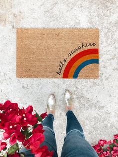 someone is standing in front of a door mat that says happy sunshine