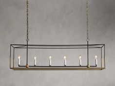 a rectangular chandelier with five candles hanging from the bottom and four lights on each end