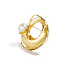 24K & 18K yellow gold, 18mm South Sea Pearl This magnificent South Sea Pearl is held in the folds of high karat gold, as if waves of the precious metal are slowly rocking amongst their lustrous frame to reveal the gift of the sea; a hidden gem from the crevasses of the ocean depths. Playing with form and space, its masterful maker, Alexandra Watkins brilliantly coaxes the gold to satisfy her wondrous imagination. The pearl's enduring opalescence beckons one's gaze as the onlooker remains entranc Hallmarked Yellow Gold Evening Brooch, Hallmarked Yellow Gold Evening Brooches, Hallmarked Yellow Gold Brooches For Evening, Evening Yellow Gold Hallmarked Brooches, Elegant Gold Brooch Jewelry, Formal Fine Jewelry Gold Brooches, Unique Yellow Gold Brooches For Gifts, Gold Round Brooches For Gifts, Exquisite Yellow Gold Brooch For Anniversary