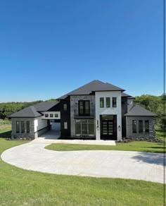 this is an image of a large house in the middle of a grassy area with trees