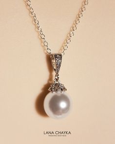 Wedding Swarovski 10mm White Pearl Drop 925 Sterling Silver Chain CZ Bridal Necklace. Classy and elegant, this necklace would be great for any wedding! CHAIN is 18 inches (45.7 cm) long. PENDANT is about 0.86 inch (2.2cm) long including bail. MATCHING EARRINGS: https://www.etsy.com/listing/99757178/bridal-white-drop-pearl-earrings?ref=shop_home_active_14 Handmade necklace, is made with .925 Sterling Silver 18 inches cable chain, Swarovski 10mm White round crystal pearl, Rhodium Sterling Silver p Wedding Pearl White Necklace With Diamond Accents, Pearl White Necklaces With Diamond Accents For Wedding, Classic Pearl Necklace With Diamond Accents For Wedding, Classic Wedding Pearl Necklace With Diamond Accents, Pearl Necklace With Diamond Accents For Wedding, Classic Silver Pearl Necklace With Diamond Accents, Wedding Pearl Necklace With Diamond Accents, Classic Round Bridal Necklace With Pearl Charm, Classic Bridal Necklace With Elegant Design