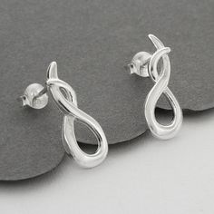 With a stunning contemporary design and a luxurious polished finish our Sterling Silver Designer Loop Earrings are a must for fashion fans everywhere.  The design features a deliciously simple loop of silver. They're both eye catching and show stopping. Why not complete the look with our matching necklace. All Martha Jackson jewellery comes in a gift box with a small gift card for you to write a message on. If you would like us to write the message for you simply select the gift message option. Modern Twist Silver Earrings For Party, Modern Silver Earrings With Polished Finish, Silver Earrings With Modern Twist And Polished Finish, Silver Earrings With Polished Finish And Modern Twist, Silver Earrings With A Modern Twist And Polished Finish, Modern Twist Silver Earrings With Polished Finish, Silver Infinity Earrings For Formal Occasions, Silver Infinity Earrings For Formal Events, Silver Earrings With Modern Twist For Anniversary