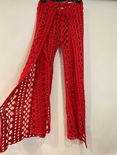 red crocheted pants hanging on the wall