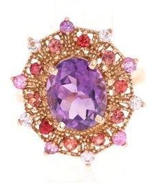 4.25 Carat Oval Cut Amethyst Sapphire Rose Gold Cocktail Ring This beautiful vintage inspired setting with a modern colorful theme has an Oval Cut Amethyst weighing 3.33 carats and is surrounded by 20 Round Cut Multi-Colored Sapphires that weigh 0.92 Carats. The total carat weight of the ring is 4.25 Carats.  The ring is made in 14 Karat Rose Gold and weighs approximately 5.5 grams.  The ring is a size 7 and complimentary ring sizing is available upon request. Luxury Purple Round Ruby Ring, Rose Gold Cocktail, Colored Sapphires, Amethyst Cocktail Ring, Red Sapphire, Jewels Rings, Gold Cocktail Ring, Gold Cocktail, Diamond Cocktail Rings