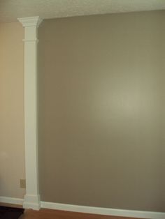 an empty room with hard wood flooring and white trim on the walls in front of it