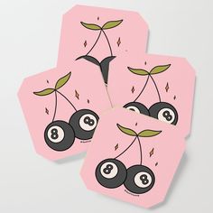 four pink playing cards with black and white billiards on the front one has green leaves